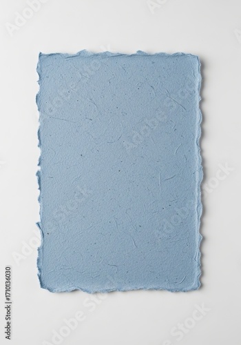A serene, dusty blue piece of handmade paper with visible fibers and a classic deckle edge, presented as a blank template for design, wall art, or a textured wallpaper background