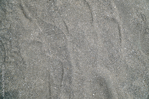 A textured backdrop of fine sand, perfect for use as a background element, isolated in white background. The subtle gradients and patterns create a versatile neutral texture.