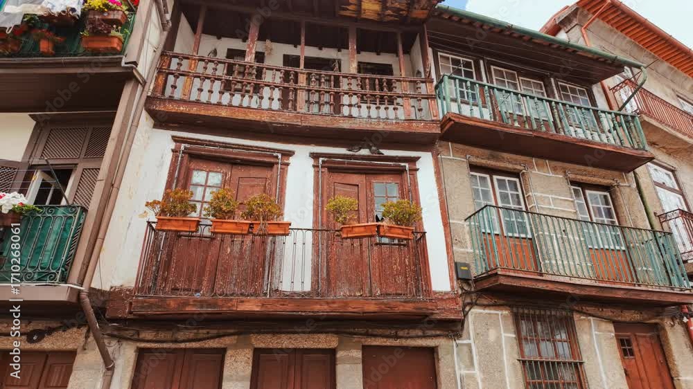 Largo da Oliveira Square in Guimaraes, Portugal features medieval arcades the Padrao do Salado monument and timber framed houses encircling lively cafe terraces