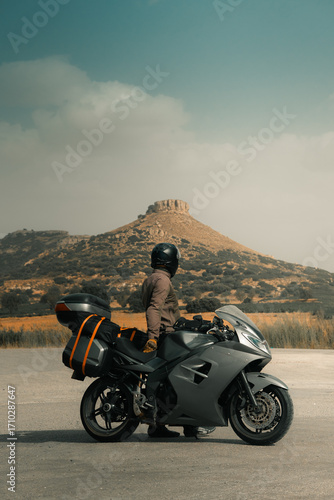 Motorcycle touring on a desert road, sports tourer motorbike with rider and luggage