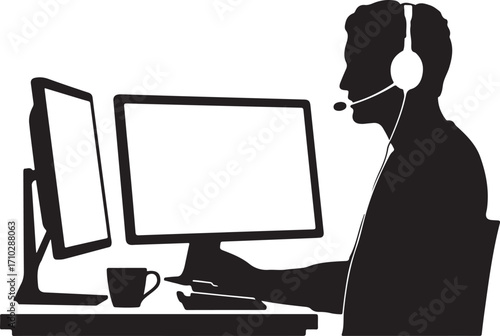 Silhouette of man with headset working at dual computer screens