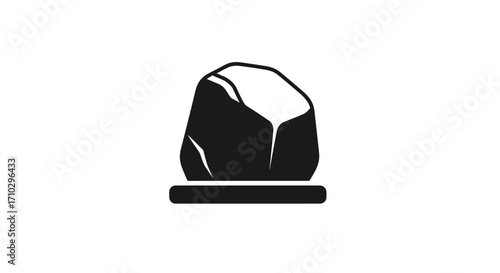 Black rock on a pedestal representing strength and stability in nature.