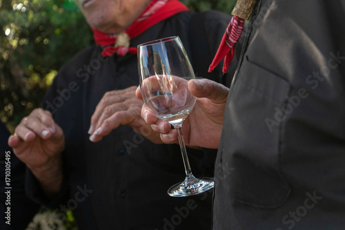 Alentejo singer of traditional 'Cante' wearing boina cap and neck scarf, holding a glass of wine, symbol of Portuguese rural culture.