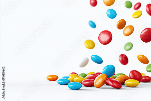 Colorful round candies falling and piling