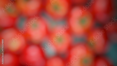 That image is a close-up, blurry shot of many red tomatoes.