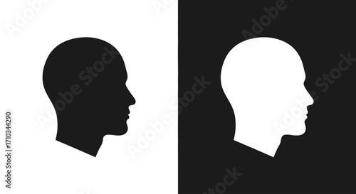 Contrasting black and white human head silhouettes in profile, symbolizing duality, opposition, and identity.