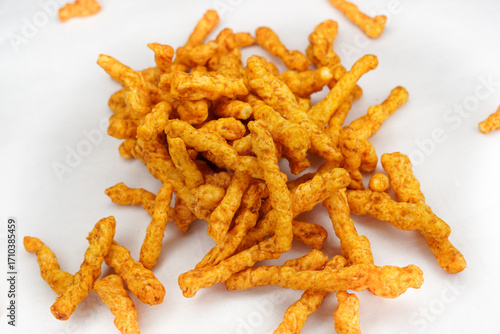 Heap of Crunchy spicy snacks isolated on white background. red chilli powder snack isolated on white background. Indian tea snacks concepts.