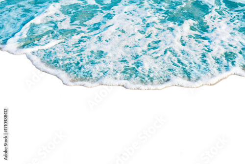 Foamy ocean waves gently wash over sandy beach, creating serene and calming scene