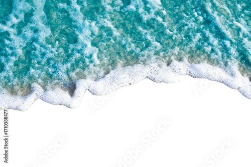 Aerial view of ocean waves crashing on shore with white foam