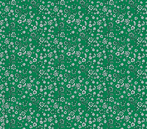 Simple ditsy floral seamless pattern with tiny white folk-style flowers on a green background. Cute and dense vintage print for textile, fabric, or wallpaper. Small botanical design.