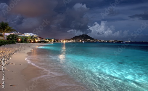 Amazing beach at night on the island, with bright turquoise water and soft sand, dramatic sky, city lights on the horizon, National Geographic photography style