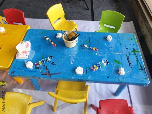 View of painting table at kids playground with blurred background. Education photography concept design.