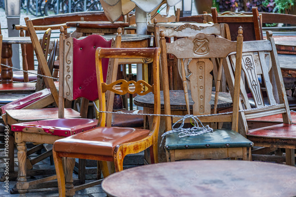 Fototapeta premium Collection of vintage wooden chairs in outdoor cafe
