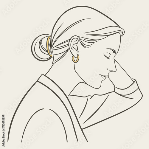 Woman with gold hoop earrings and hair bun
