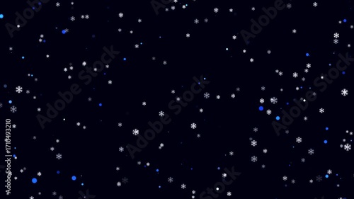 Delicate snowflakes fall softly against a dark, starry sky in winter's embrace.