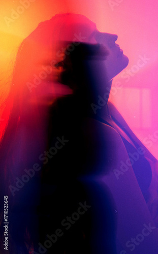 moody experimental portrait of a brunette woman with orange-pink-red glow in cyberpank style