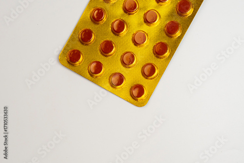 Yellow blister pack of tuberculosis tablets isolated on a white background with a coffee space. Tuberculosis medication in the pack in the 4th month of consumption period.