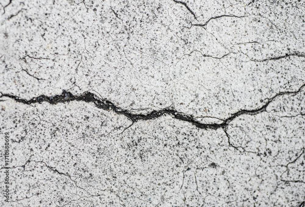 Fototapeta premium Cracks on the cement floor, close-up. Abstract background.