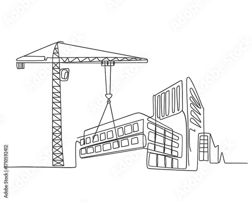 Crane lifting building module onto construction site