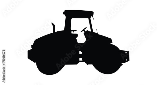 A stark silhouette of a heavy road roller machine against white background
