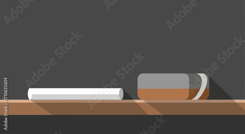 A white chalk stick and a brown and grey eraser rest on a wooden shelf in front of a dark chalkboard, ready for learning or drawing.