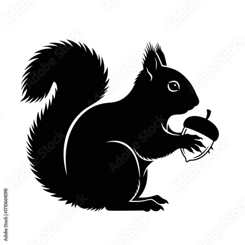 Black silhouette of a squirrel holding an acorn