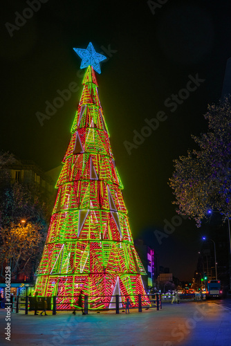 Christmas tree with colored lights on a street in Madrid, Spain