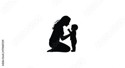 A silhouette of a mother kneeling while interacting with her baby