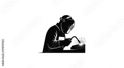 Silhouette of a welder working with metal sparks flying intensely