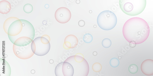 Soapy bright multicolored bubbles fly randomly on a white background. Beautiful circles colorful soap bubbles texture background. Design soap bubbles on a white background. Soap bubbles randomly flew.