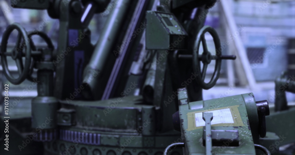 Fototapeta premium A large industrial machine is actively working in a manufacturing facility. It demonstrates complex mechanisms and precision engineering. Surrounding materials and equipment are evident.