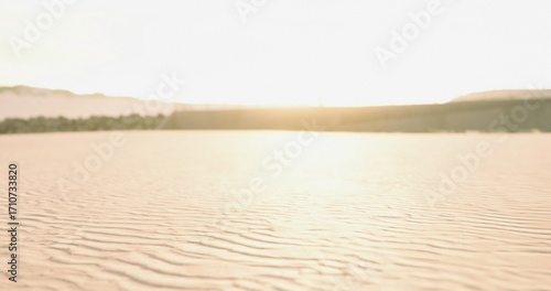 Tableau sur toile Bright sunlight reflects on gently rippling sand at the beach