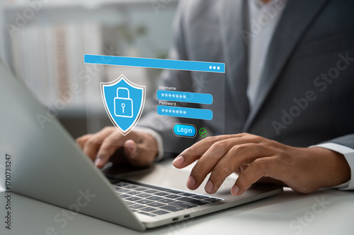 Cybersecurity concept, Businessman typing on laptop with login interface and shield icon, representing cyber security, password protection, secure access, data privacy, Digital identity verification.