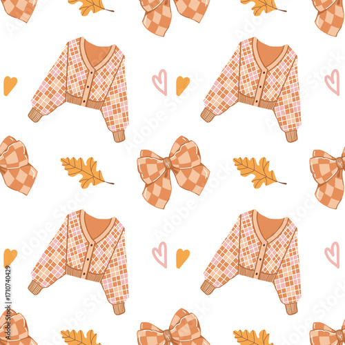 A warm and cozy autumnal seamless pattern. Sweater, bow, autumn clothes, leaves, and hearts on a white background. Colorful background with Fall elements and attributes for girls and women. Vector