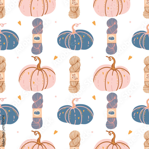 Seamless autumn pattern with hand-drawn pink and blue pumpkins, skeins of yarn, and hearts on a white background. Cute and cozy autumn background. Decorative pumpkins. Pastel colors. Vector flat