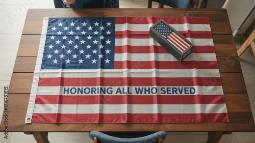 American flag with honoring all who served text and flag box on a wooden table surface