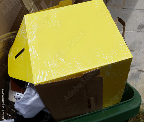 Yellow box in trash bin