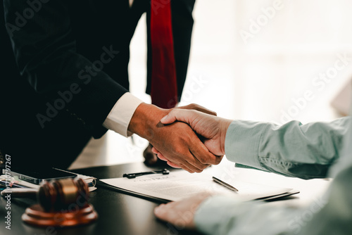 Portrait of lawyer in law office hand shake giving advice and advice on lawsuit consulting concept