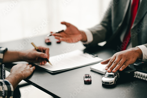 Принти на полотні Portrait of a car sales contract signing, a broker advising a client on signing or refinancing a car