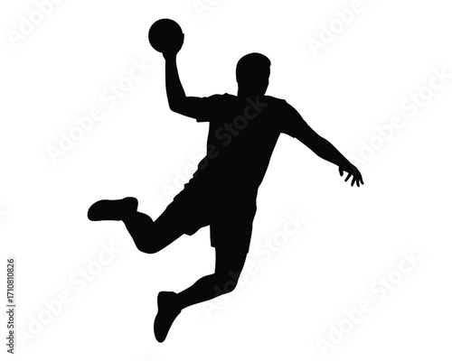 Silhouette of a handball player in mid air throwing the ball