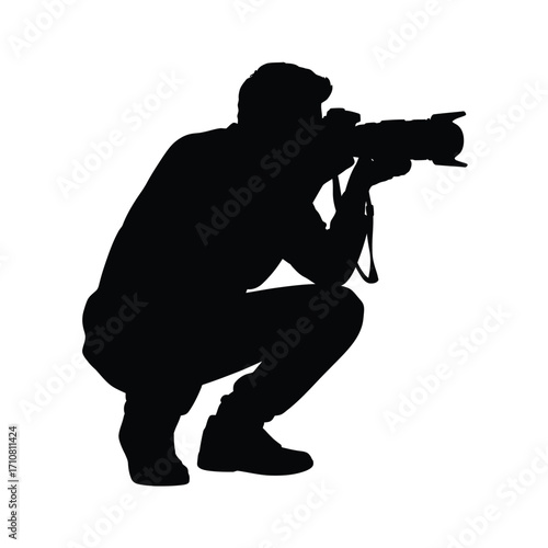 Silhouette of a photographer crouching and taking a photo