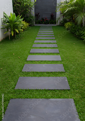 Stepping stone pathway through a vibrant green lawn in a modern backyard, embodying clean and simple landscape architecture
