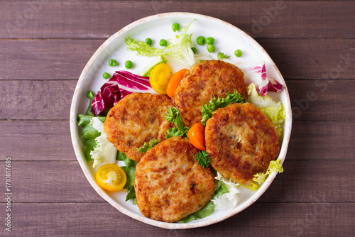 Fish patty burgers served with vegetables. Fish cakes. High angle view