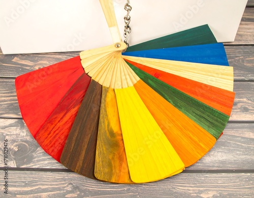 Colorful wooden paint swatches arranged in a fan