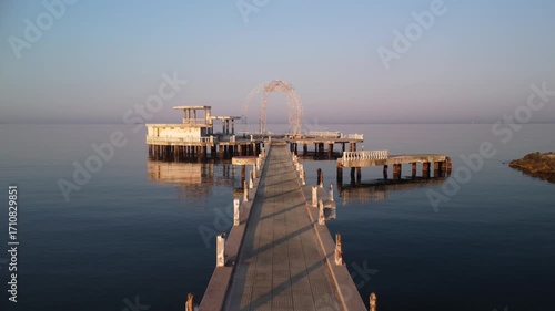Aerial drone video from an abandoned pier or building in the sea.