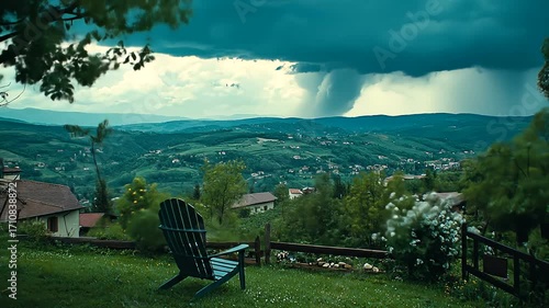 A tranquil vista of rolling hills, a moody sky, and a peaceful wooden chair.