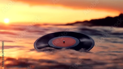 A vibrant vinyl record floats atop a tranquil ocean during a beautiful sunset.