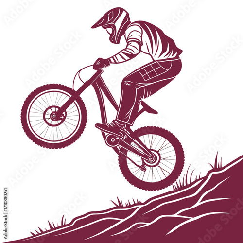 Dynamic silhouette of a downhill mountain biker in full protective gear performing a jump on a rugged terrain