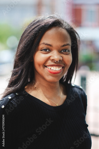 Young Black Business Woman in an urban environment smiling