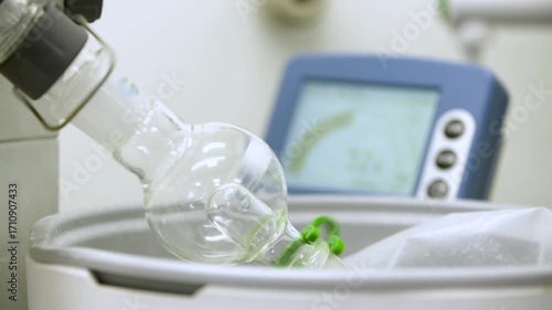 Close-up detailed view of a laboratory pressurizing system with a spinning glass container, showing changing pressure readings on a computer — perfect for themes of science, chemistry, research, and p